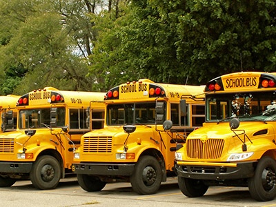 Parked school bus fleet with gps tracker telematics.