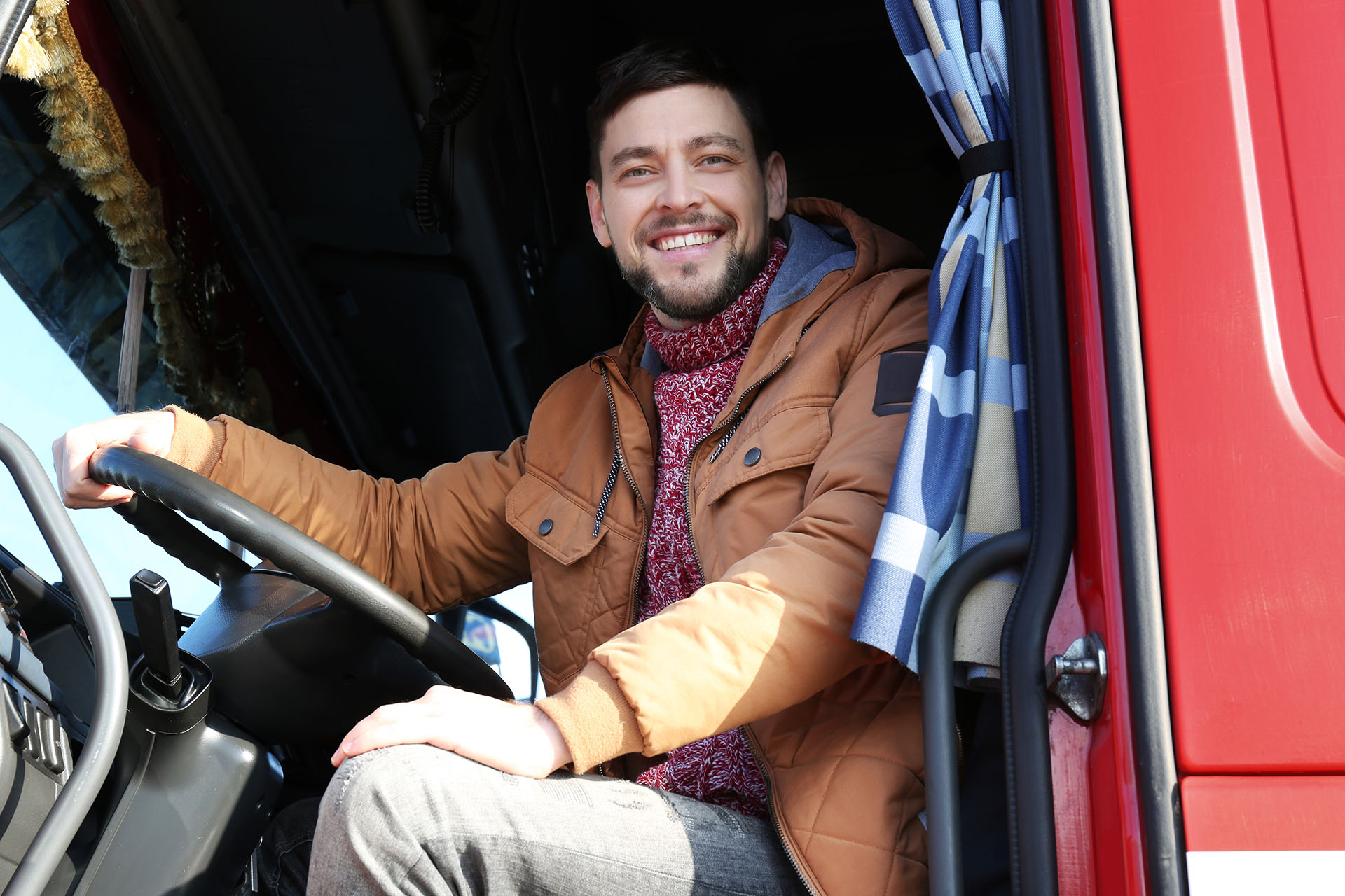 Smiling driver in a truck cab.
